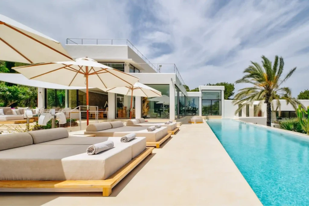 event villas in ibiza with a luxurious double sun beds next to large pool in Ibiza luxury villa for events