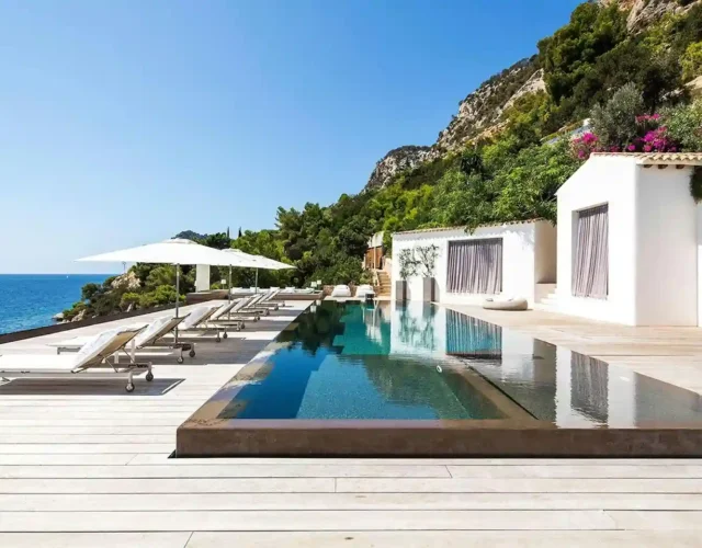 Luxury villa in Ibiza with a large swimming pool and mountain views.