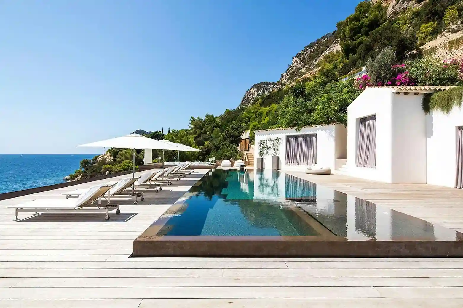 Luxury villa in Ibiza with a large swimming pool and mountain views.