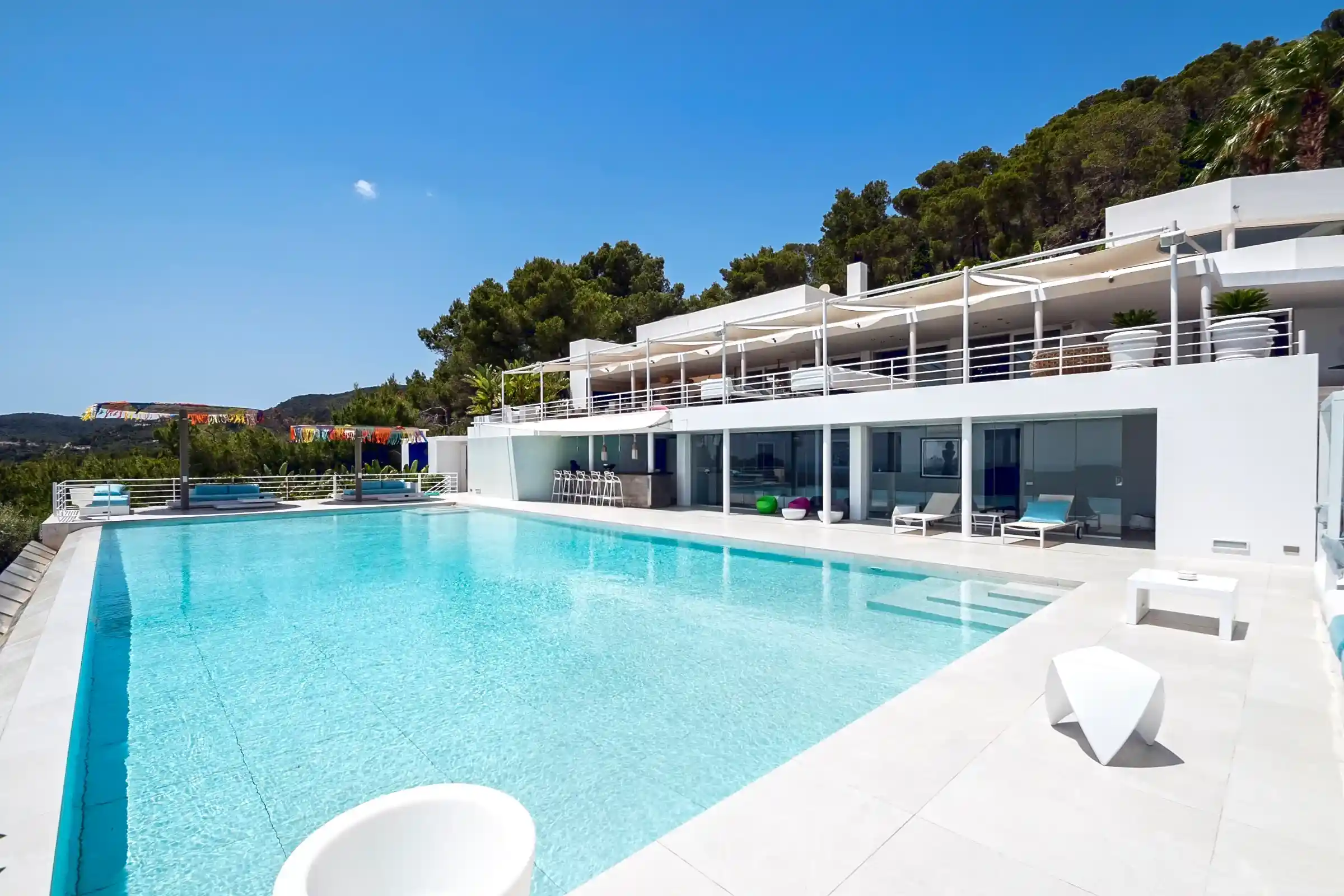 impressive pool in front of breathtaking big villa in ibiza