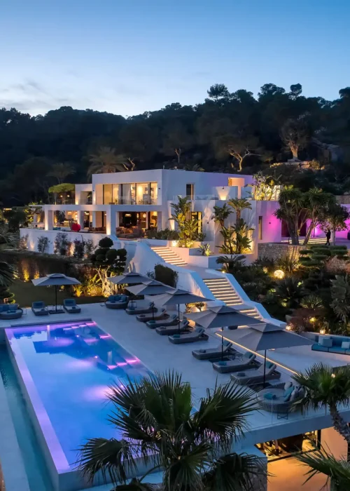 Elegant villa with a swimming pool, overlooking majestic mountains in the distance.