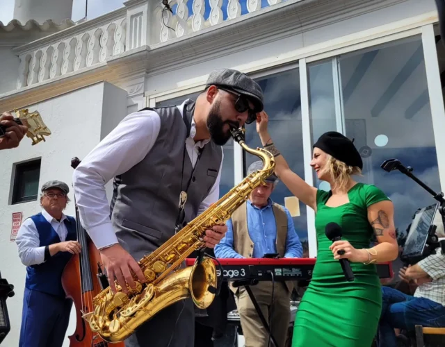 A well-dressed man performing on a saxophone, exuding sophistication and passion for music.